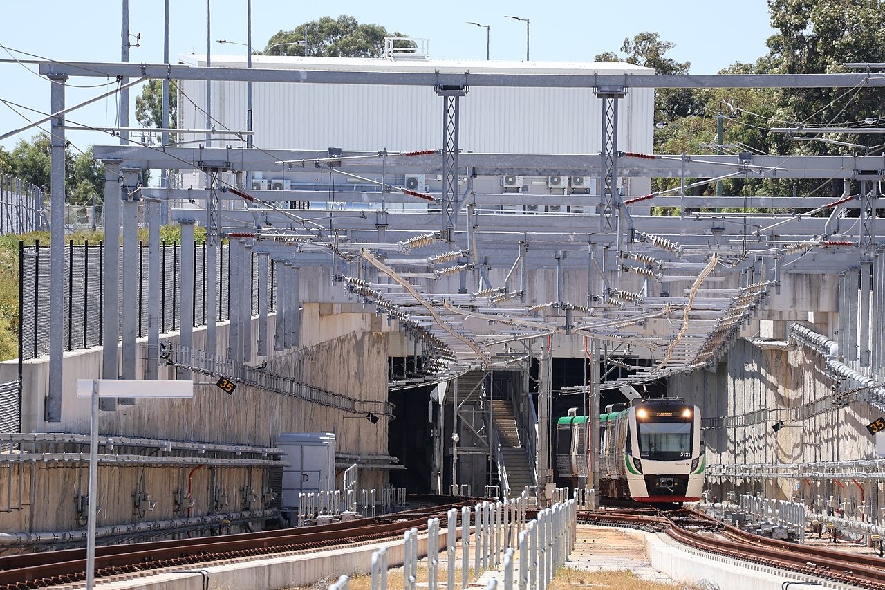 The High Wycombe dive structure, viewed from the platform at High Wycombe railway station. This is where Perth's Airport line enters a tunnel to pass under Perth Airport. A Transperth B-series train is shown exiting the tunnel.