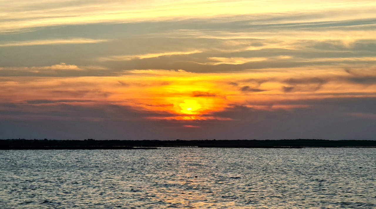 Sunset near Patimban Deep Sea Port, Subang, West Java, Indonesia. The land on horizon is Cipunagara River delta.