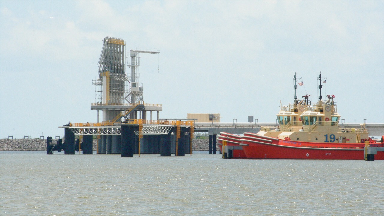 The following is the author's description of the photograph quoted directly from the photograph's Flickr page. "Chiksan arms and tugboats ready to assist inbound LNG tankers at Sabine Pass."
