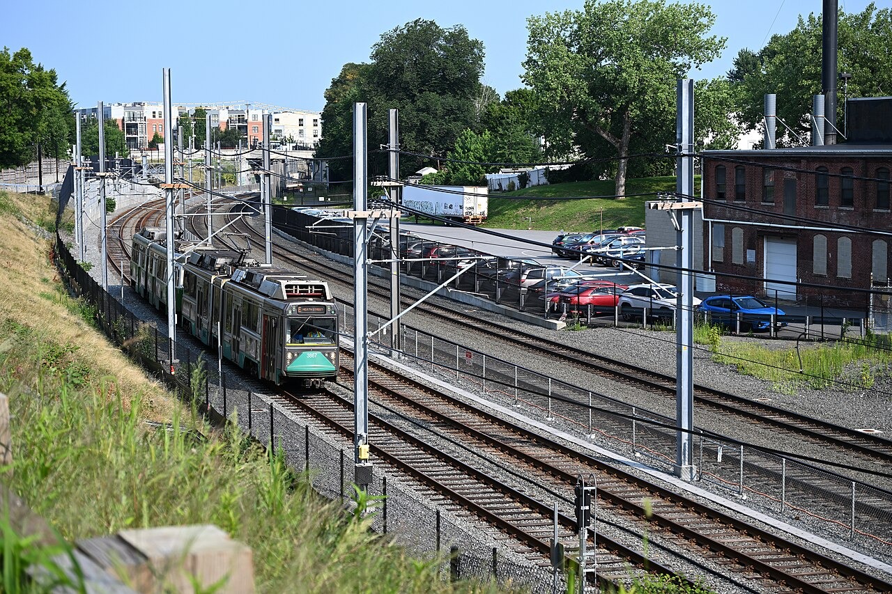 A Heath Street-bound E branch train on the Green Line Extension between Gilman Square and Magoun Square in August 2024