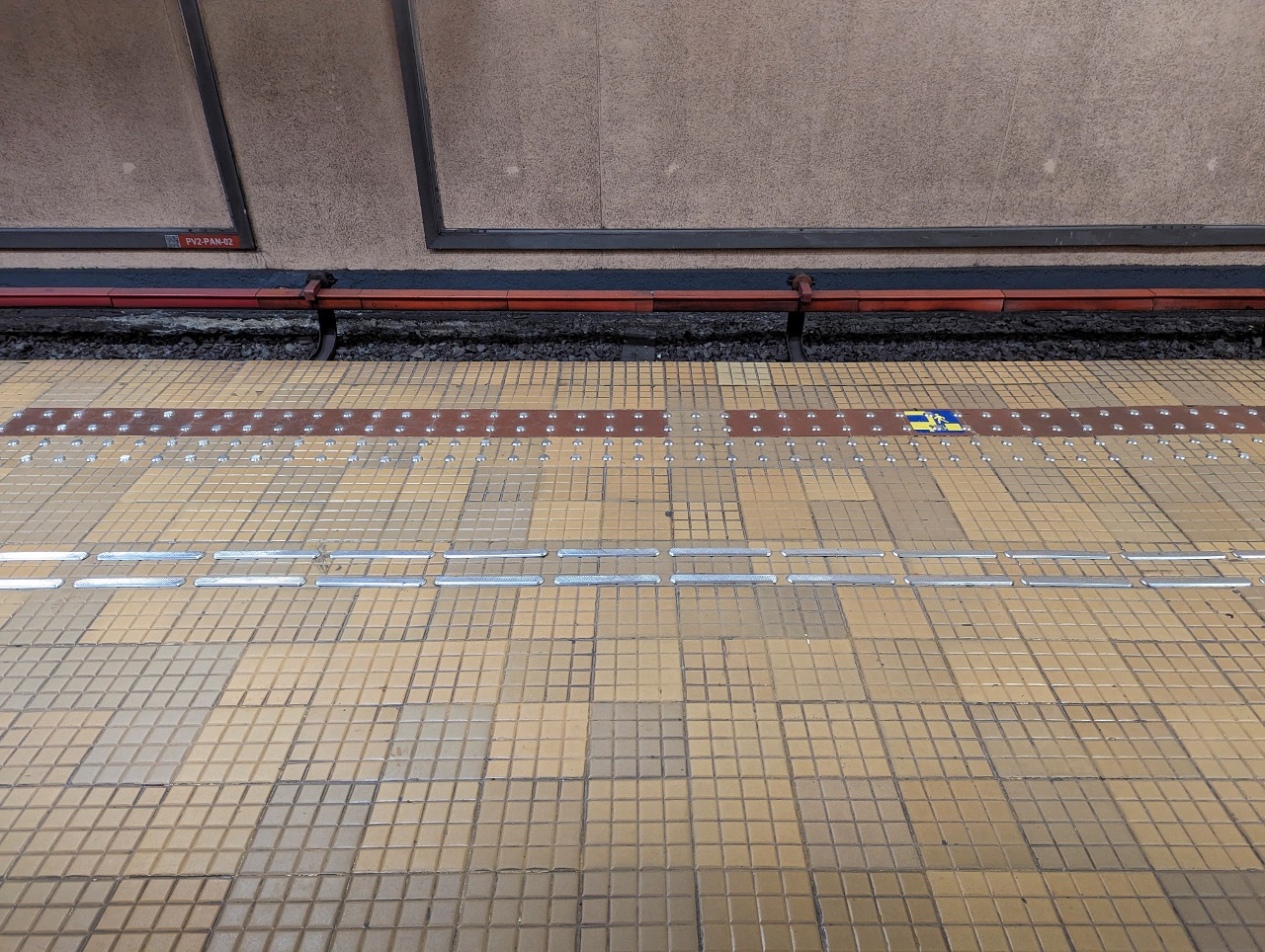 Photo of the M1 platform of Piața Victoriei metro station, Bucharest, Romania showing the tactile paving for visually impaired pedestrians